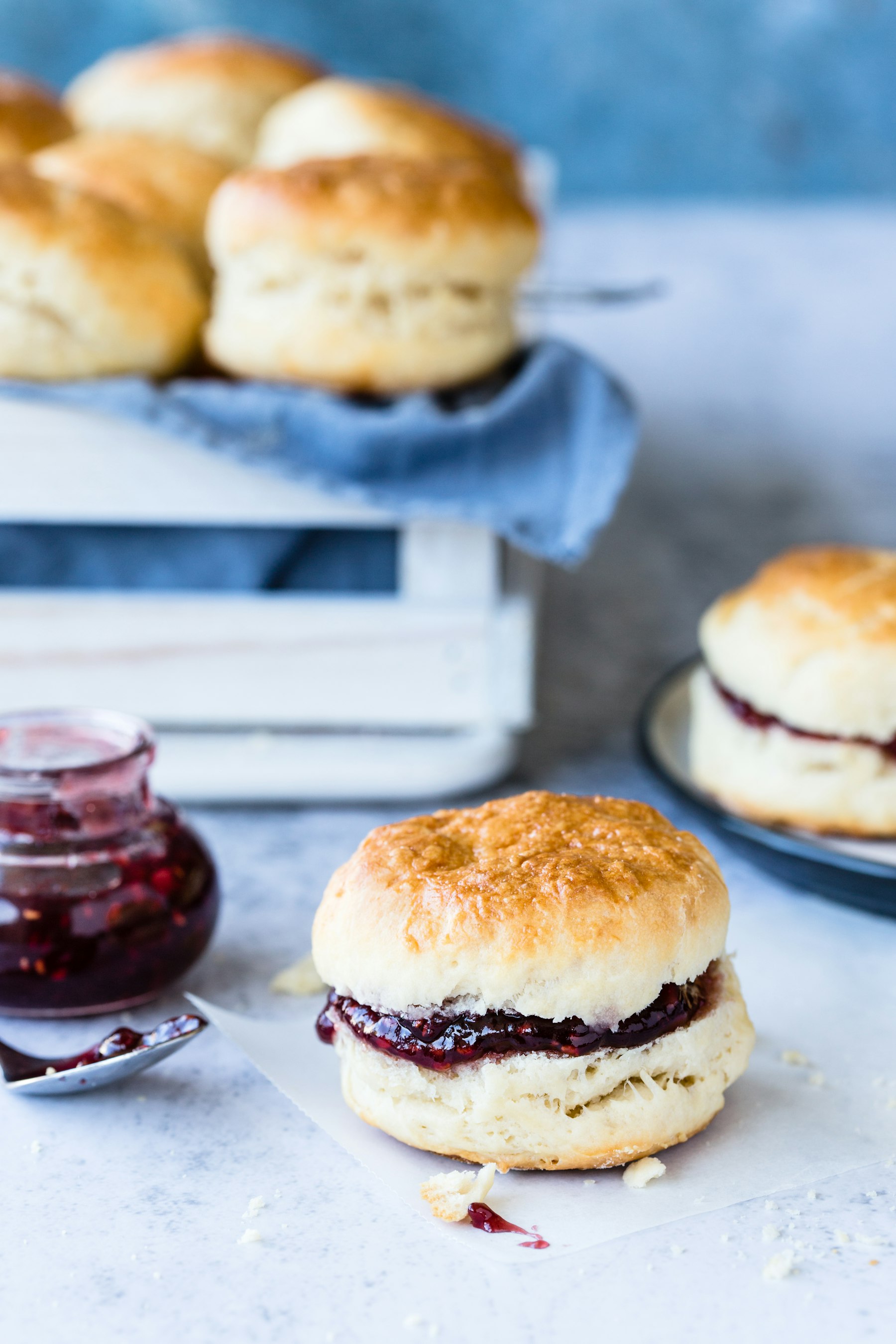 Fresh croissants and homemade jam on a linen-set table.