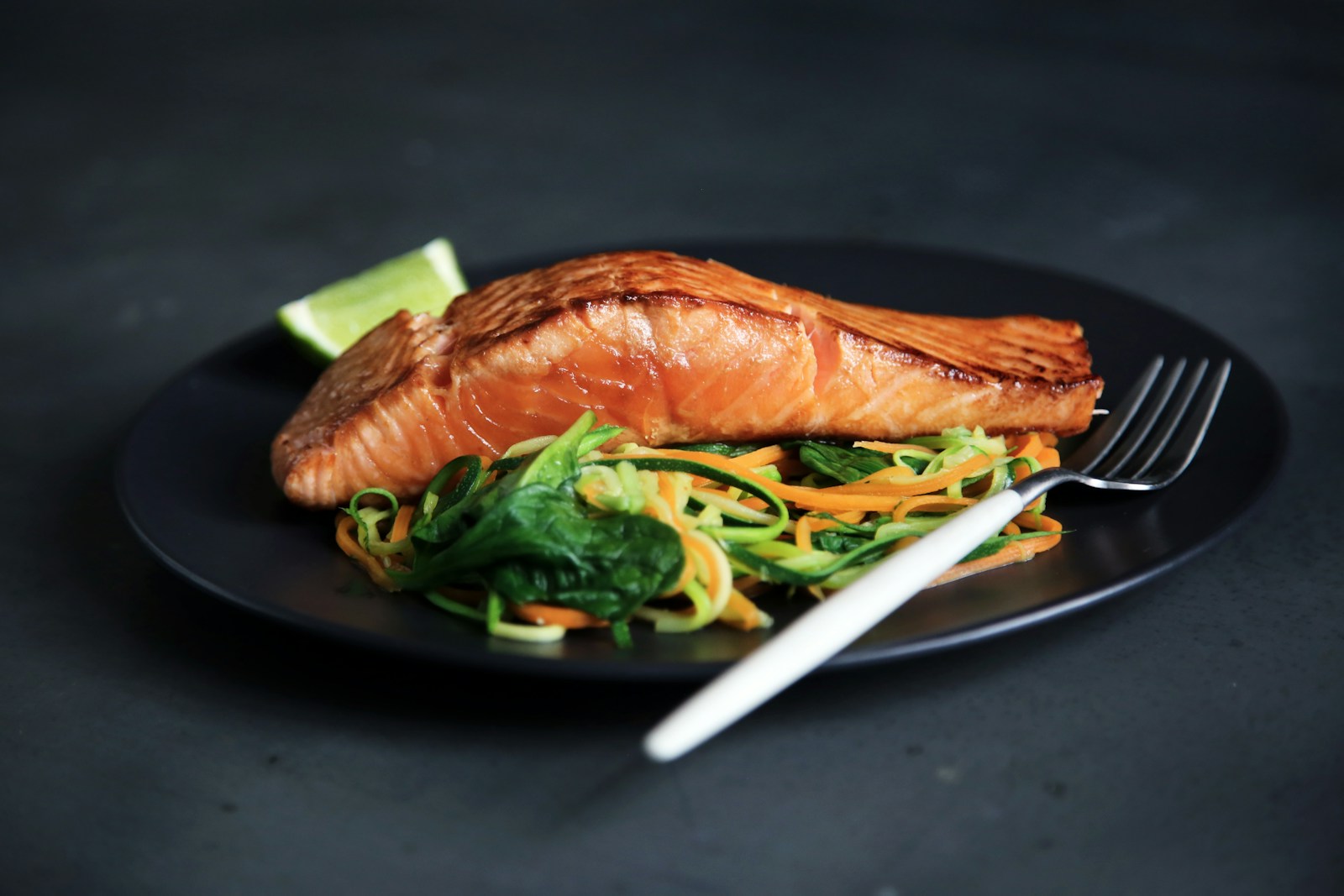A clean, thoughtfully composed plate of grilled fish and vegetables.
